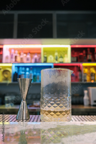 Bartender making a fancy craft cocktail at a bright colourful speakeasy bar in Hong Kong