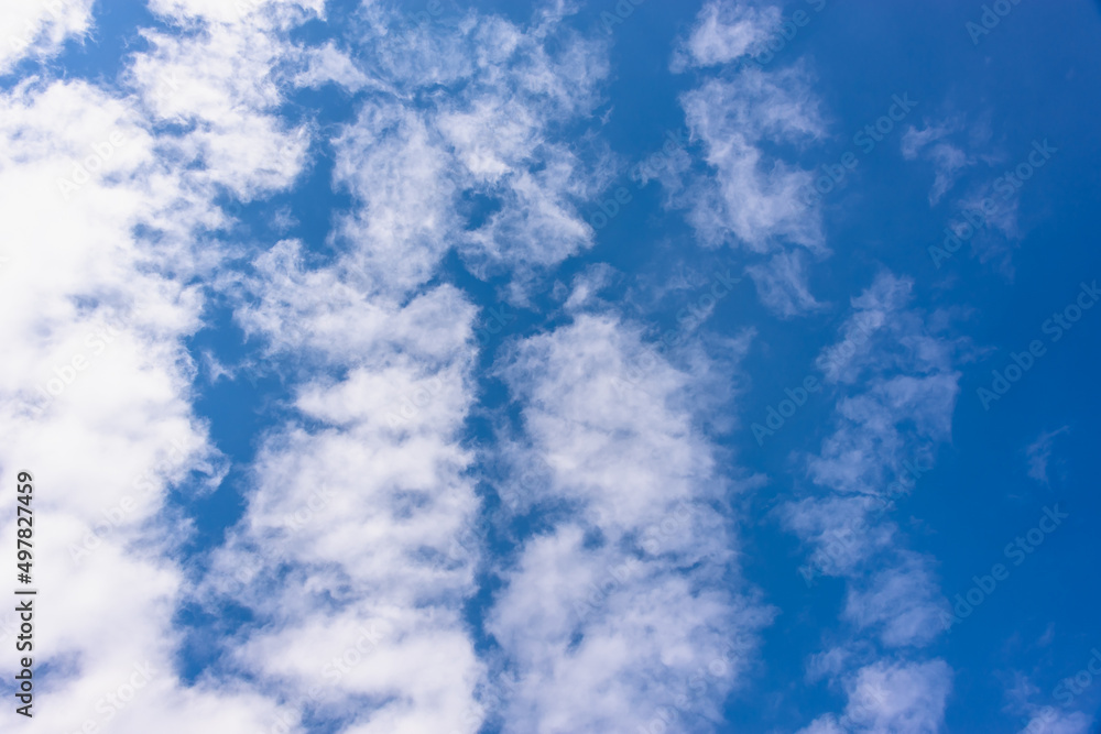 Blue sky with stripes of clouds.