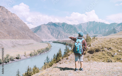 young hiker boy standing in the countryside