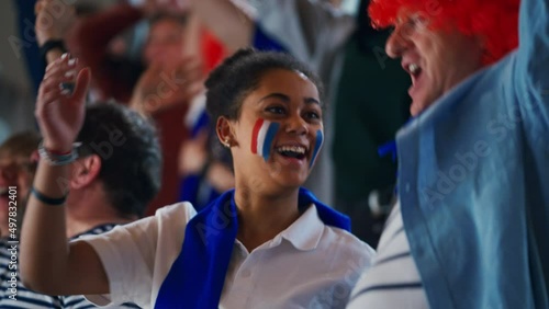 French football fans celebrating their team's victory at stadium.