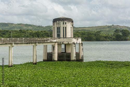 An intake or outlet tower with a service bridge at Caliraya lake and dam in the province of Laguna, Philippines. photo