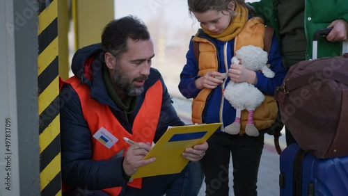 Volunteer registring Ukrainian refugees at train station. photo
