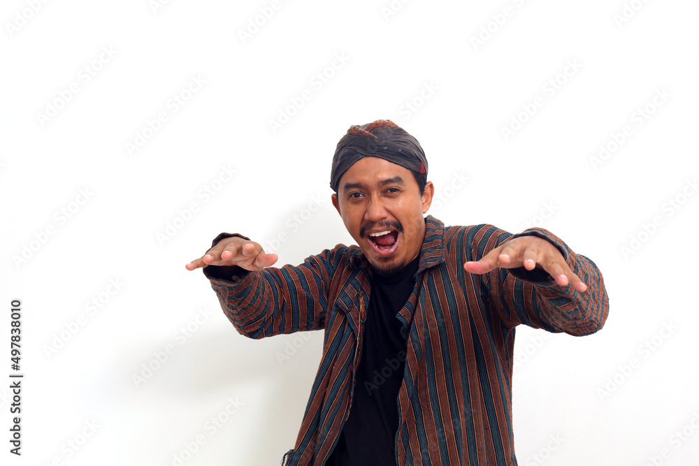 Happy asian man in java traditional costume standing while dancing ...