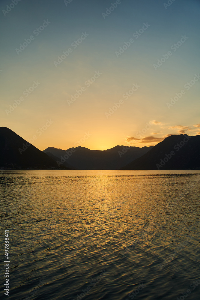 Fototapeta premium View of the sunset in Boko-Kotor Bay in Montenegro. Silhouettes of mountains