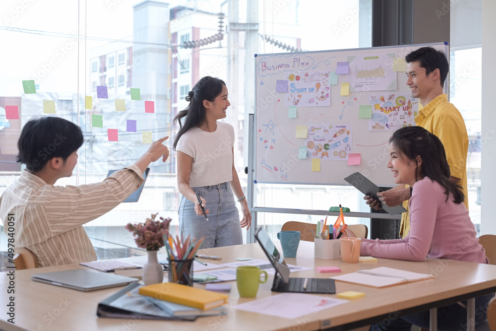 Group of young businesspeople brainstorming and discussing ideas for new startup project together at creative office. Group of young businesspeople brainstorming and discussing ideas for new startup project together at creative office.