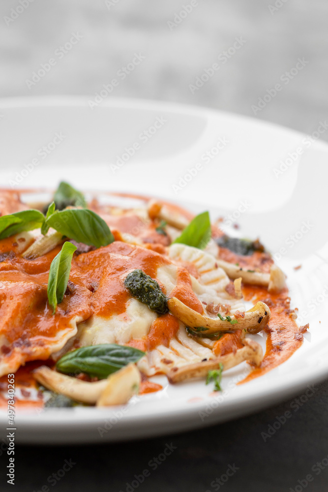 vegan mixed vegetable ravioli pasta with tomato and pumpkin sauce