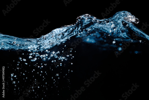 Water Wave. Water Surface with Ripple and Bubbles Float Up on Black Background. 