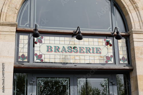 brasserie restaurant text sign paint on wall facade french building city street photo