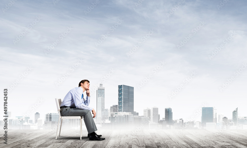Young businessman sitting on an office chair Young businessman sitting on an office chair