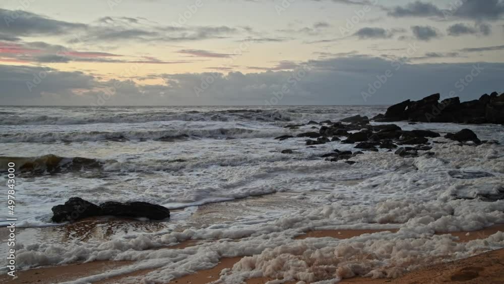 Sunrise seascape with sea foam and rain clouds Sunrise seascape with sea foam and rain clouds