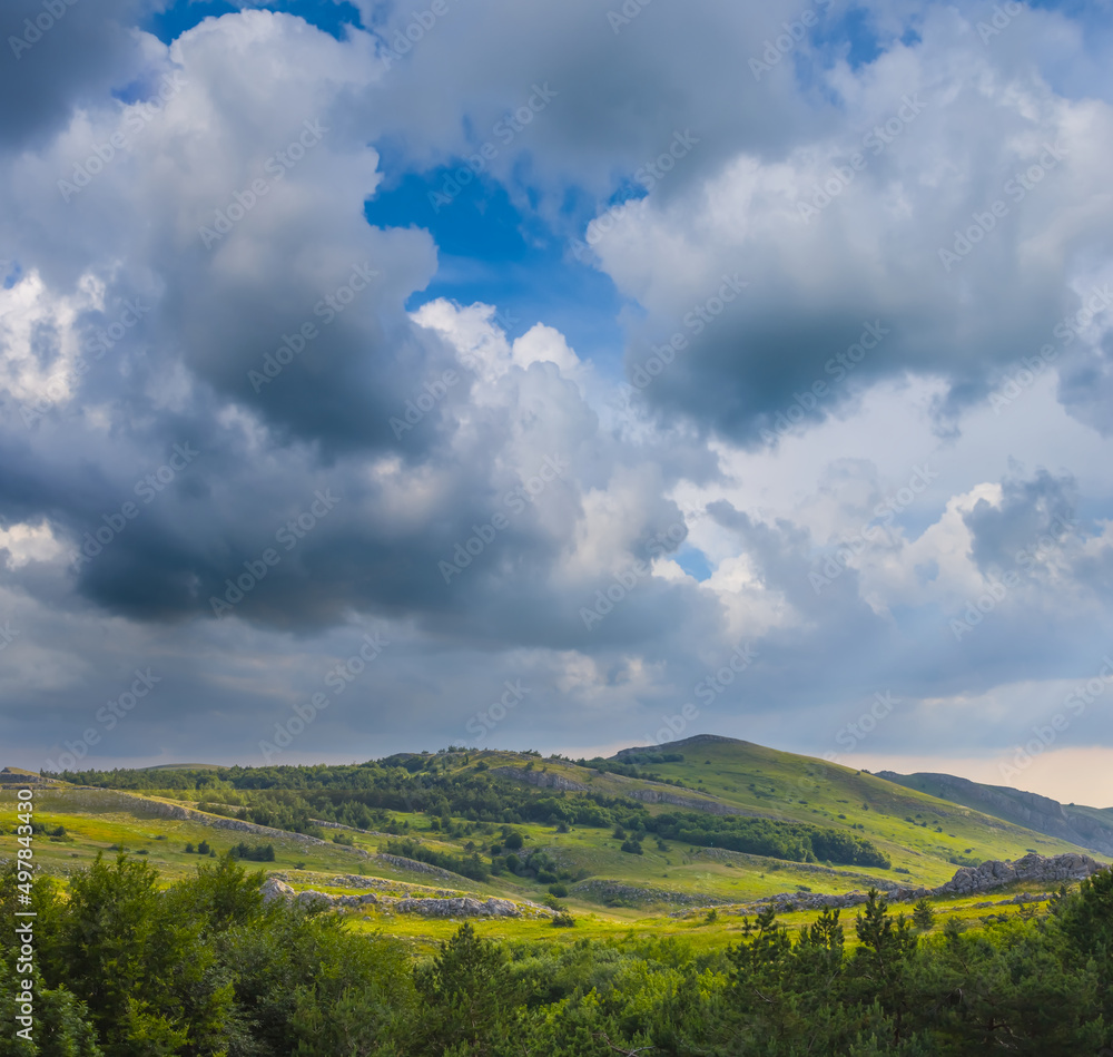 green mountain valley under dense cloudy sky green mountain valley under dense cloudy sky