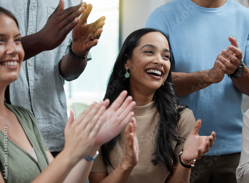 Wow, Im impressed. Shot of a young businesswoman applauding with her colleagues in an office.