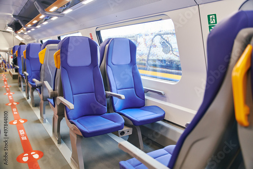 Modern high speed train interior with empty blue seats © Dima Anikin