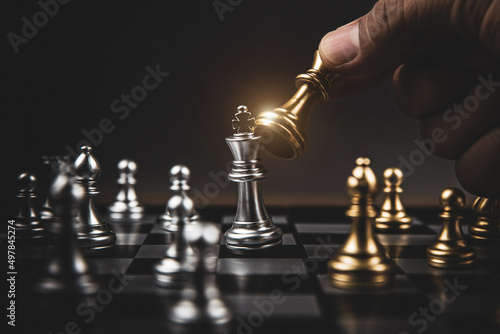 Close up hand choose king chess challenge or battle fighting on chessboard concepts of leadership and strategy or strategic plan and human resource or risk management or team player.