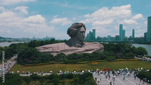 Aerial orbiting shot of young Mao Zedong statue in Changsha city
