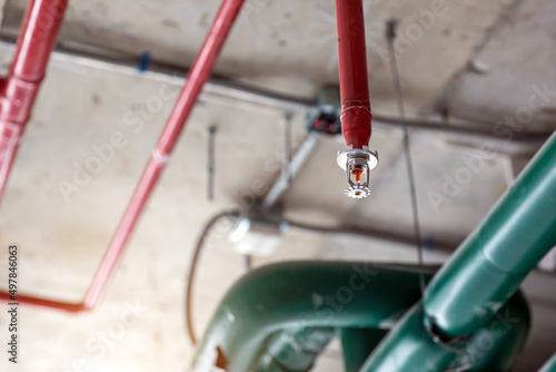 Close-up fire sprinkler on the ceiling for fire detection and alarm system equipment in building safety security protect and prevent or prevention when heat or flame detector is alert.
