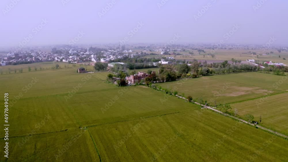 An aerial perspective of a village with an old king mainson in Punjab a state in India An aerial perspective of a village with an old king mainson in Punjab a state in India