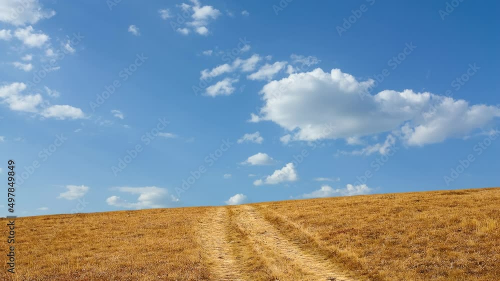 dry prairie with ground road under clouds time lapse scene dry prairie with ground road under clouds time lapse scene