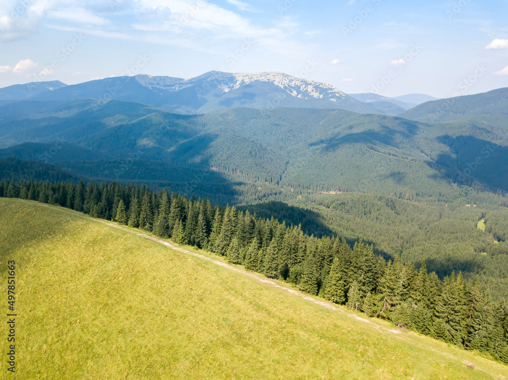 Green mountains of Ukrainian Carpathians in summer. Sunny day, rare clouds. Aerial drone view. Green mountains of Ukrainian Carpathians in summer. Sunny day, rare clouds. Aerial drone view.