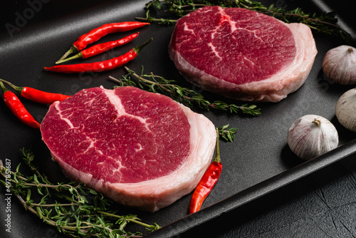 Raw tenderloin steak, on gray stone table background