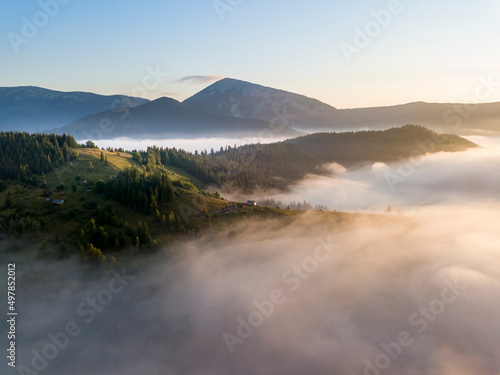 Sunrise over the fog in the Ukrainian Carpathians. Aerial drone view.