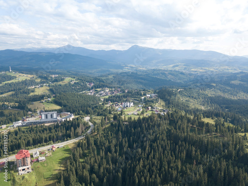 Green mountains of Ukrainian Carpathians in summer. Coniferous trees on the slopes. Aerial drone view.