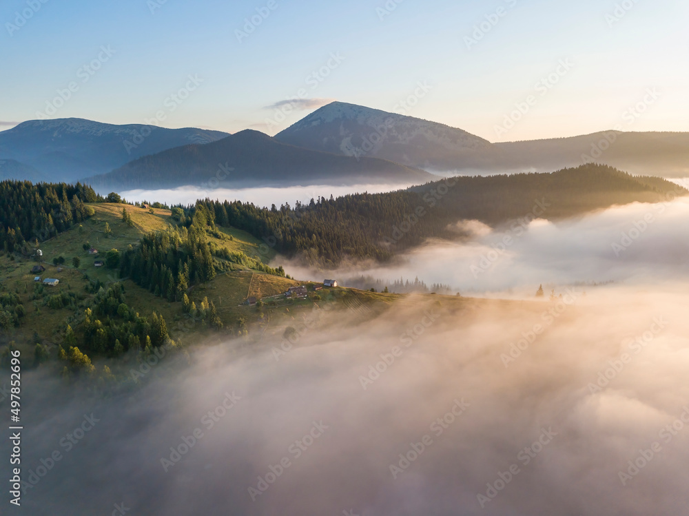 Sunrise over the fog in the Ukrainian Carpathians. Aerial drone view. Sunrise over the fog in the Ukrainian Carpathians. Aerial drone view.