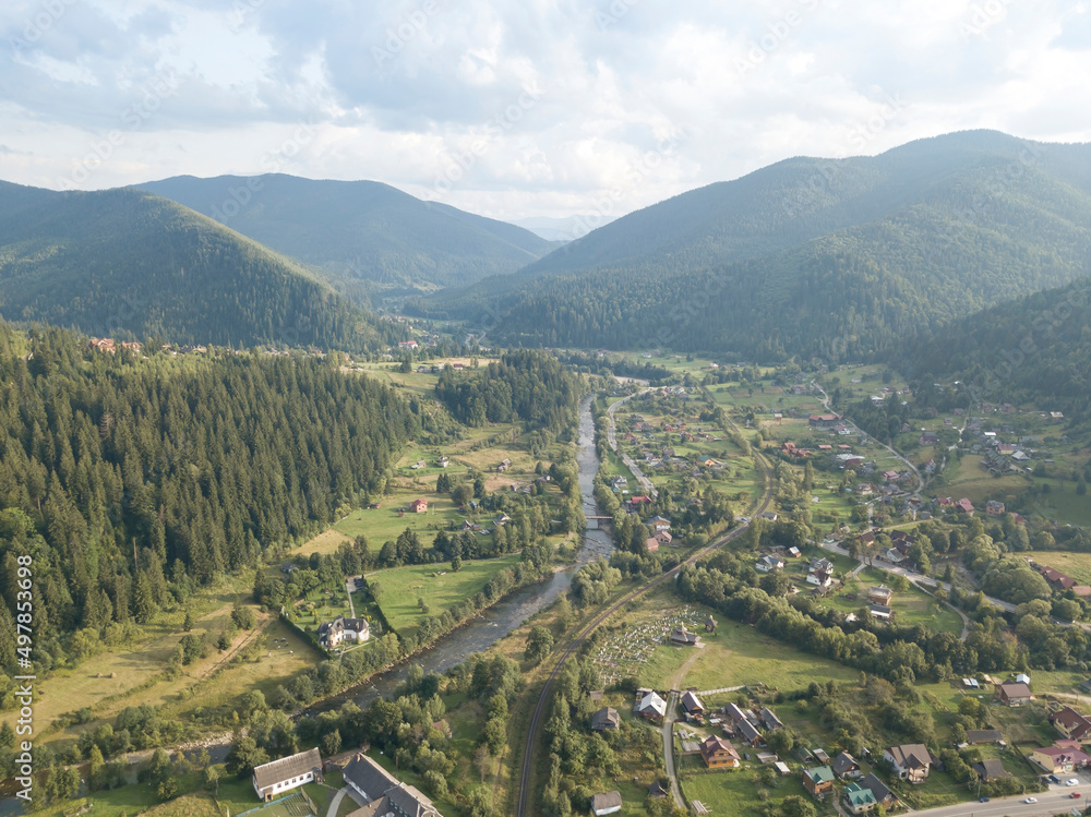Obraz premium Green mountains of Ukrainian Carpathians in summer. Coniferous trees on the slopes. Aerial drone view.