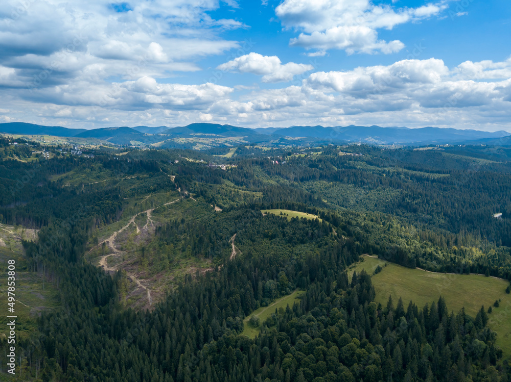 Green mountains of Ukrainian Carpathians in summer. Coniferous trees on the slopes. Aerial drone view. Green mountains of Ukrainian Carpathians in summer. Coniferous trees on the slopes. Aerial drone view.