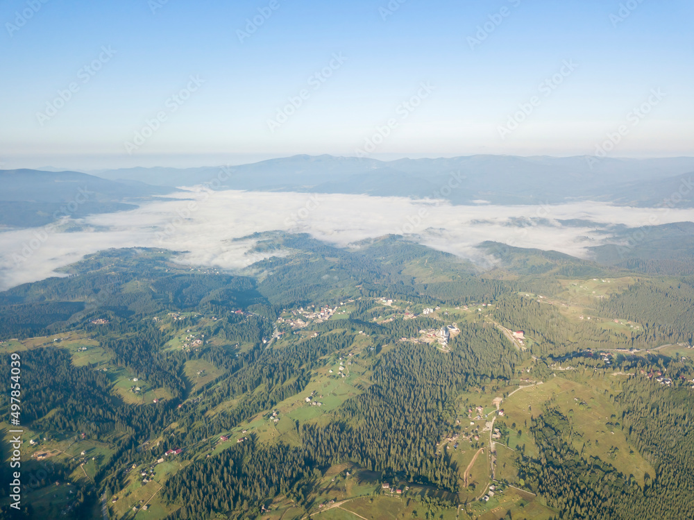 High flight in the mountains of the Ukrainian Carpathians. Fog in the valley. Aerial drone view. High flight in the mountains of the Ukrainian Carpathians. Fog in the valley. Aerial drone view.