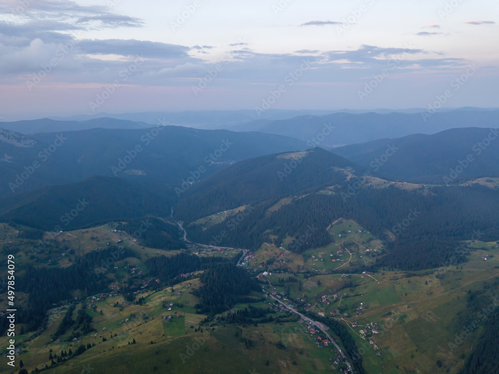 Sunset over the mountains in the Ukrainian Carpathians. Evening. Aerial drone view. Sunset over the mountains in the Ukrainian Carpathians. Evening. Aerial drone view.