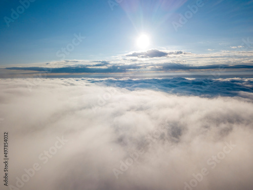High flight above the clouds. Aerial drone view.