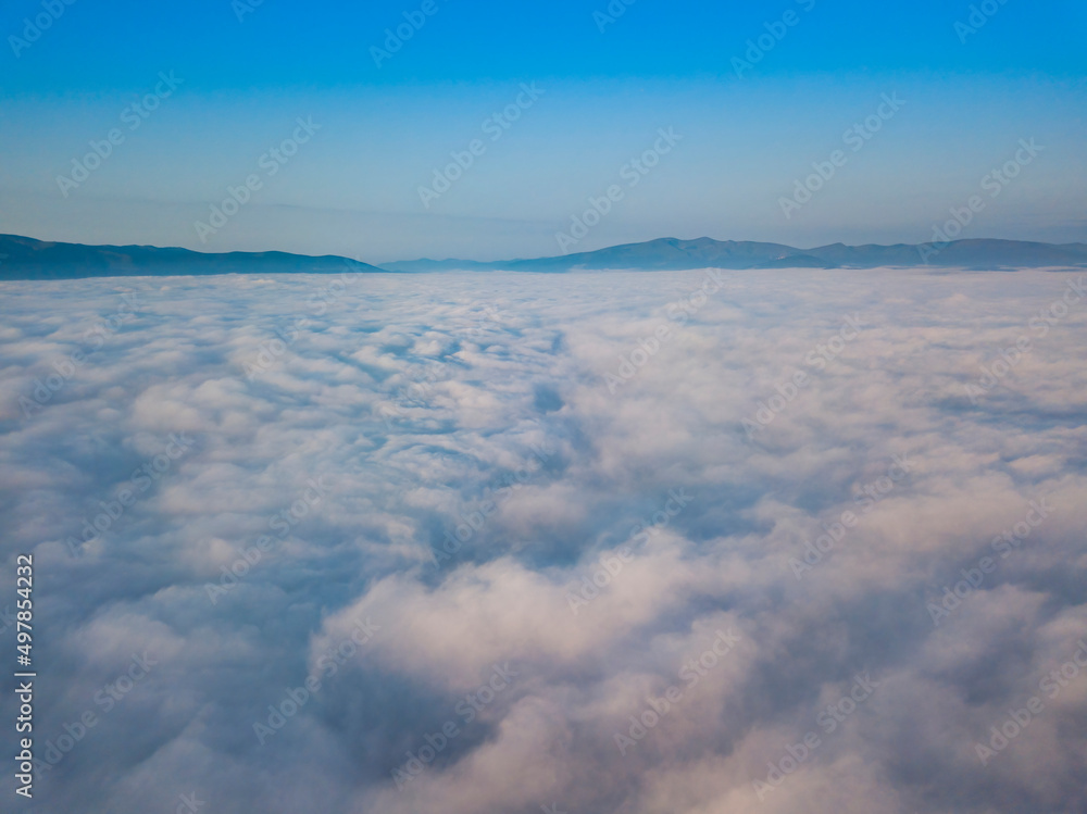 Flight over fog in Ukrainian Carpathians in summer. Mountains on the horizon. Aerial drone view. Flight over fog in Ukrainian Carpathians in summer. Mountains on the horizon. Aerial drone view.