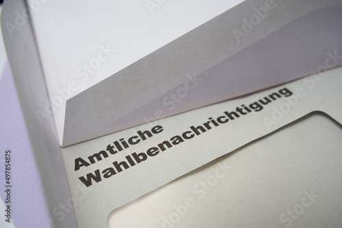 Black letters on white envelope saying: Official election notification (german: Amtliche Wahlbenachrichtigung). 2021 federal election in germany. 2 opened envelopes on the side.