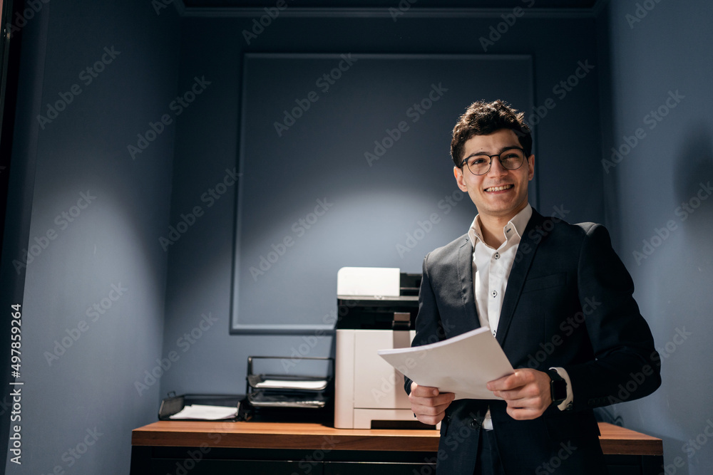 The manager in glasses, a man in formal clothes, works in an office in a coworking The manager in glasses, a man in formal clothes, works in an office in a coworking