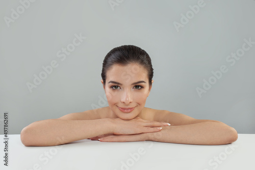 Skin care. Woman with beauty face and healthy facial skin portrait. Beautiful smiling spa model with natural makeup on white background