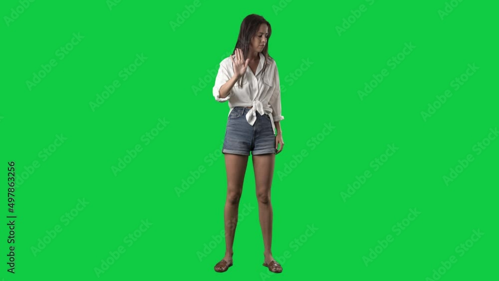 Angry woman showing various negative threat gestures at camera. Full body isolated on green screen background Angry woman showing various negative threat gestures at camera. Full body isolated on green screen background