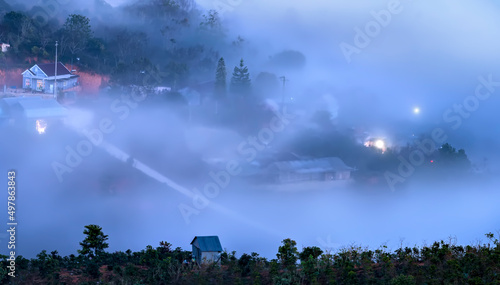 Night scene hillside a small town in fog shrouded by colorful houses and lights makes night in highlands of Da Lat, Vietnam so beautiful