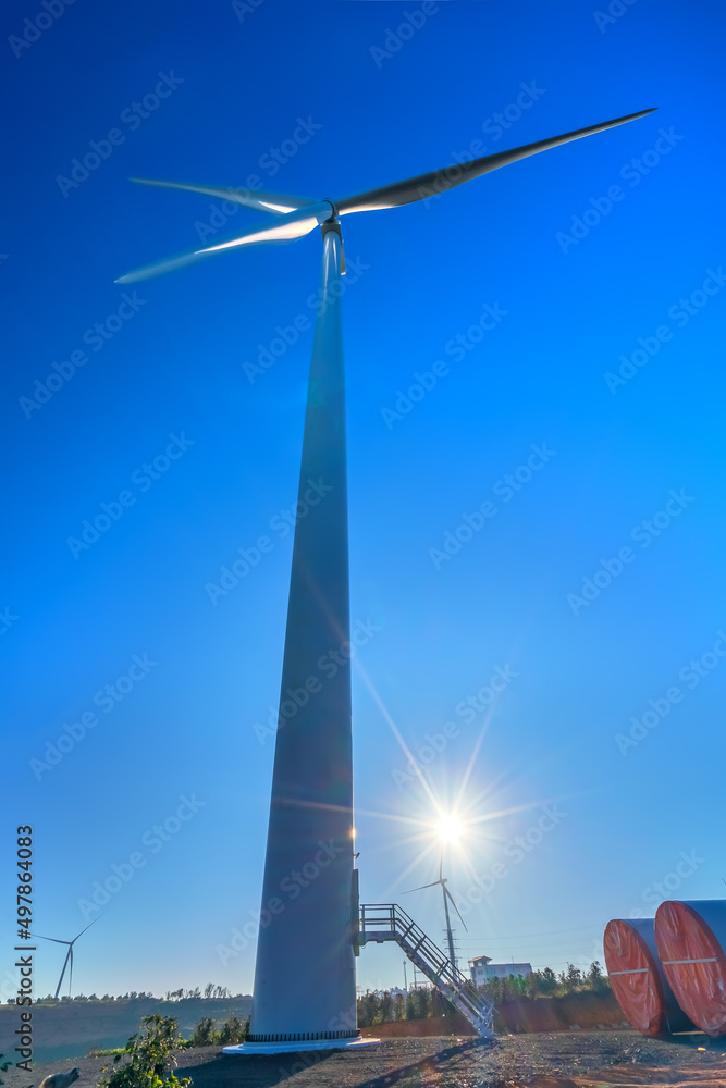 Wind turbines on the top of the hill in the morning. This is a clean energy source that does not pollute the environment to serve electricity for people Wind turbines on the top of the hill in the morning. This is a clean energy source that does not pollute the environment to serve electricity for people