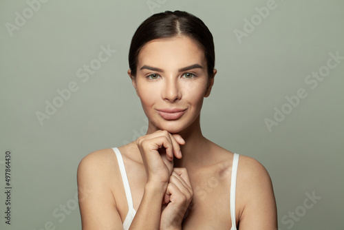 Portrait of beautiful woman on light green background