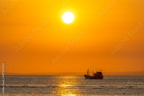 Sunset landscape when fishing boats out to sea to harvest fish end the day.