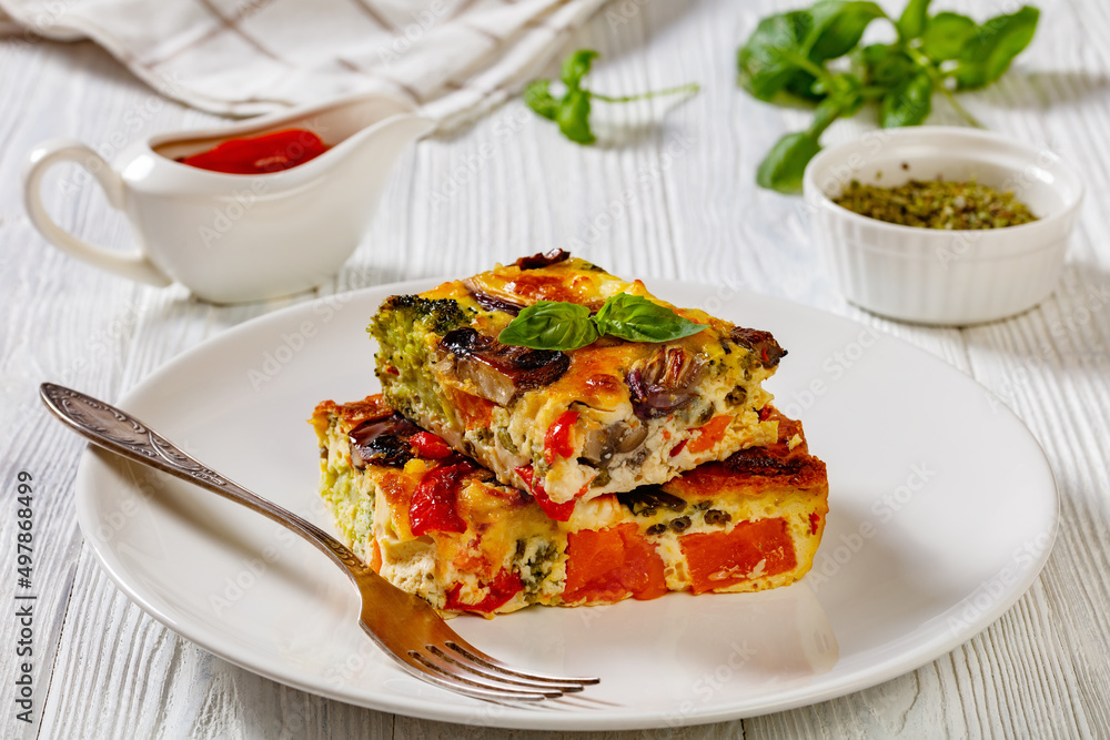 a portion of baked in oven vegetable frittata a portion of baked in oven vegetable frittata