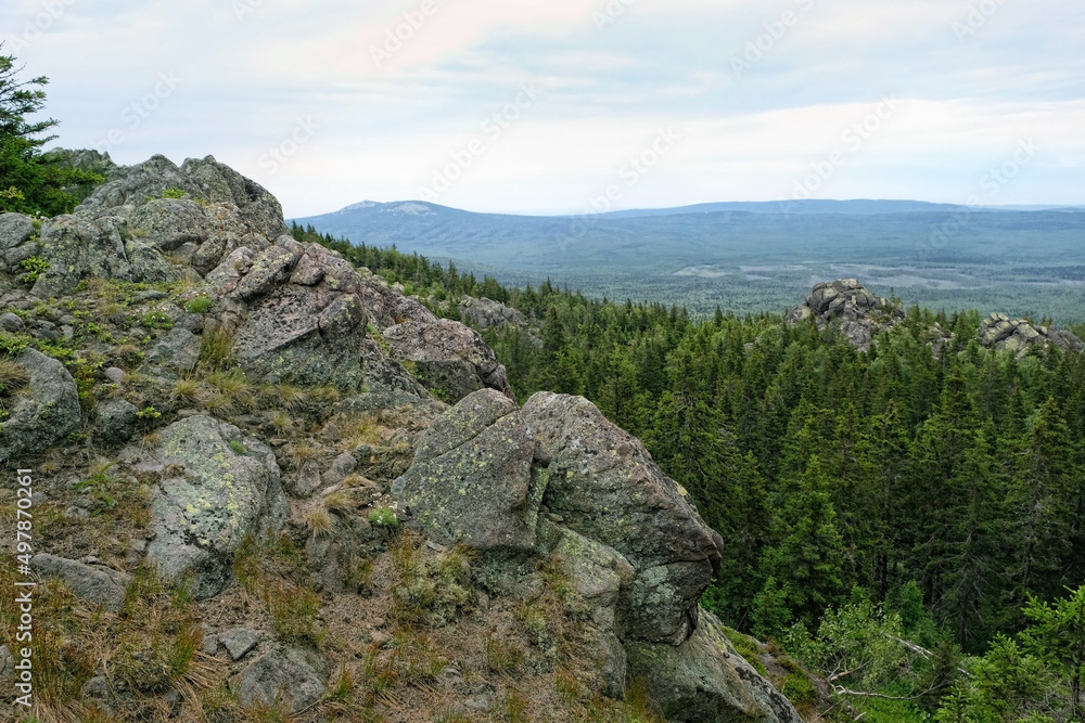 summer landscape with mountains and forest. old stones, slope rocks natural background. travel trip, journey, hiking, adventure, concept. National Park Taganay, Southern Ural, Russia