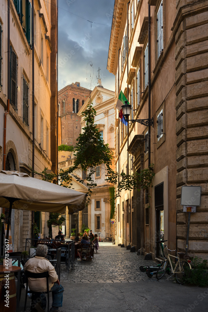 Obraz premium Street cafe on narrow old street in Rome