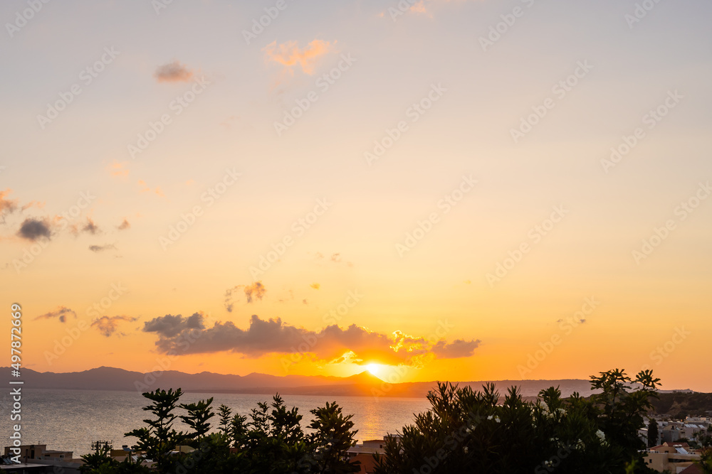 Beautiful blazing sunset landscape at black sea and orange sky above it with awesome sun golden reflection on calm waves as a background. Amazing summer sunset view on the beach Beautiful blazing sunset landscape at black sea and orange sky above it with awesome sun golden reflection on calm waves as a background. Amazing summer sunset view on the beach