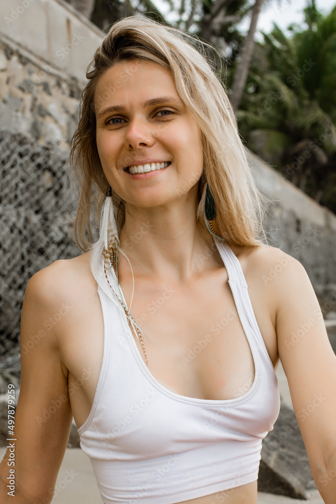 Close-up portrait of beautiful smiling female relaxing in the nature on warm sunny day. Vertical photo Close-up portrait of beautiful smiling female relaxing in the nature on warm sunny day. Vertical photo