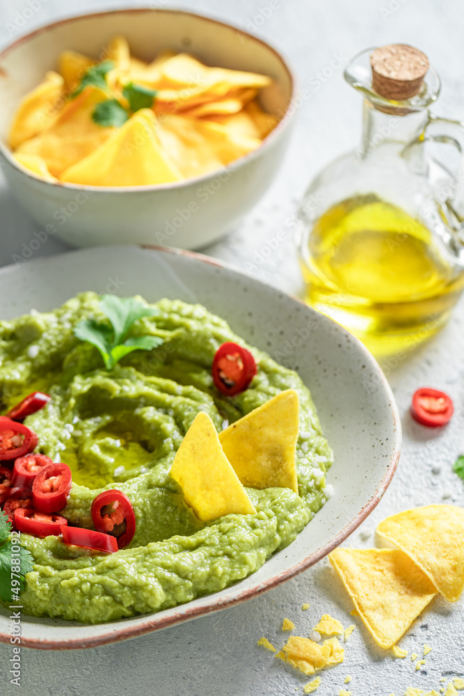 Vegan and homemade guacamole as a spicy mexican appetizer. Vegan and homemade guacamole as a spicy mexican appetizer.