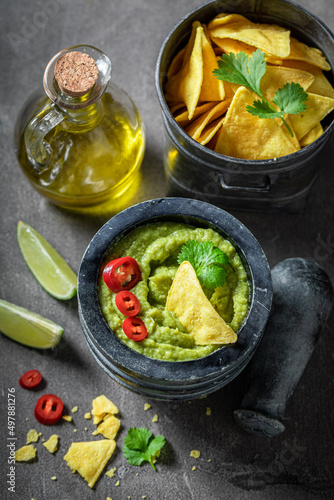 Tasty and homemade guacamole as a spicy mexican appetizer.