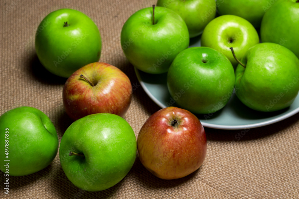The apples lie on the burlap. Different varieties of apples. ripe fruit The apples lie on the burlap. Different varieties of apples. ripe fruit