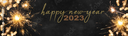 2023 Silvester Party New year background banner panorama long, holiday greeting card - Sparklers and bokeh lights on dark night texture, with space for text